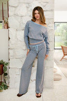 Woman wearing BELLAMY stripe sweater knit pants featuring a soft stripe sweater knit fabric, mid rise waistband with adjustable drawstring closure, relaxed straight leg silhouette, and pull on design for comfortable lounge and casual styling.