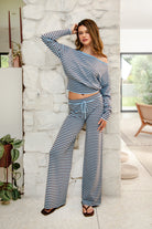 Woman wearing BELLAMY stripe sweater knit pants featuring a soft stripe sweater knit fabric, mid rise waistband with adjustable drawstring closure, relaxed straight leg silhouette, and pull on design for comfortable lounge and casual styling.