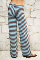 Woman wearing BELLAMY stripe sweater knit pants featuring a soft stripe sweater knit fabric, mid rise waistband with adjustable drawstring closure, relaxed straight leg silhouette, and pull on design for comfortable lounge and casual styling.