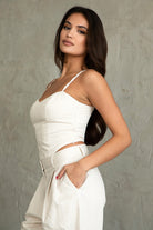 TH29606-SOPHEA Classic Natural Linen Cami Top is your go-to for effortless warm-weather style. Featuring a flattering V-neckline, adjustable spaghetti straps, and a smocked back for added comfort and stretch, this cami is finished with an asymmetrical curved hem for a soft, elevated touch. Made from a breathable linen blend perfect for lounging, summer travel, or a breezy boho-inspired look.

Pairs perfectly with matching pieces (sold separately: PA31289, TH29602).

50% VISCOSE, 35% LINEN, 15% POLYESTER, LI