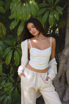 TH29606-SOPHEA Classic Natural Linen Cami Top is your go-to for effortless warm-weather style. Featuring a flattering V-neckline, adjustable spaghetti straps, and a smocked back for added comfort and stretch, this cami is finished with an asymmetrical curved hem for a soft, elevated touch. Made from a breathable linen blend perfect for lounging, summer travel, or a breezy boho-inspired look.

Pairs perfectly with matching pieces (sold separately: PA31289, TH29602).

50% VISCOSE, 35% LINEN, 15% POLYESTER, LI