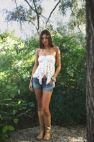 Woman wearing TIC TOC TH31655 APRICOT floral stripe sheer babydoll tank top featuring soft stretch lace fabric with delicate floral and stripe print, a ruched strapless bust, layered sheer design with light milk lining, and a ruffled handkerchief hem for a romantic western-inspired summer look.