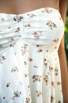 Woman wearing TIC TOC TH31655 APRICOT floral stripe sheer babydoll tank top featuring soft stretch lace fabric with delicate floral and stripe print, a ruched strapless bust, layered sheer design with light milk lining, and a ruffled handkerchief hem for a romantic western-inspired summer look.