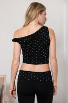 Woman wearing TIC TOC TH31776-JAIME-TP JAIME lightweight one shoulder polka dot top featuring a soft micro polka dot stretch fabric, asymmetrical off-the-shoulder neckline, twist strap detail, side ruching, and a slim hip-length silhouette for a chic day-to-night look.