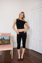 Woman wearing TIC TOC TH31776-JAIME-TP JAIME lightweight one shoulder polka dot top featuring a soft micro polka dot stretch fabric, asymmetrical off-the-shoulder neckline, twist strap detail, side ruching, and a slim hip-length silhouette for a chic day-to-night look.