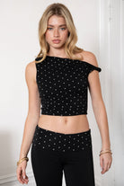 Woman wearing TIC TOC TH31776-JAIME-TP JAIME lightweight one shoulder polka dot top featuring a soft micro polka dot stretch fabric, asymmetrical off-the-shoulder neckline, twist strap detail, side ruching, and a slim hip-length silhouette for a chic day-to-night look.