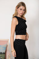 Woman wearing TIC TOC TH31776-JAIME-TP JAIME lightweight one shoulder polka dot top featuring a soft micro polka dot stretch fabric, asymmetrical off-the-shoulder neckline, twist strap detail, side ruching, and a slim hip-length silhouette for a chic day-to-night look.