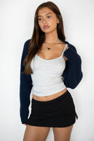 Woman wearing TIC TOC TH32025BA-ROMIE ROMIE V-neck spaghetti strap tank top featuring a delicate picot trim neckline, slim body hugging rib jersey fabric, and adjustable straps, styled with casual bottoms for an easy everyday lounge-and-layering look.