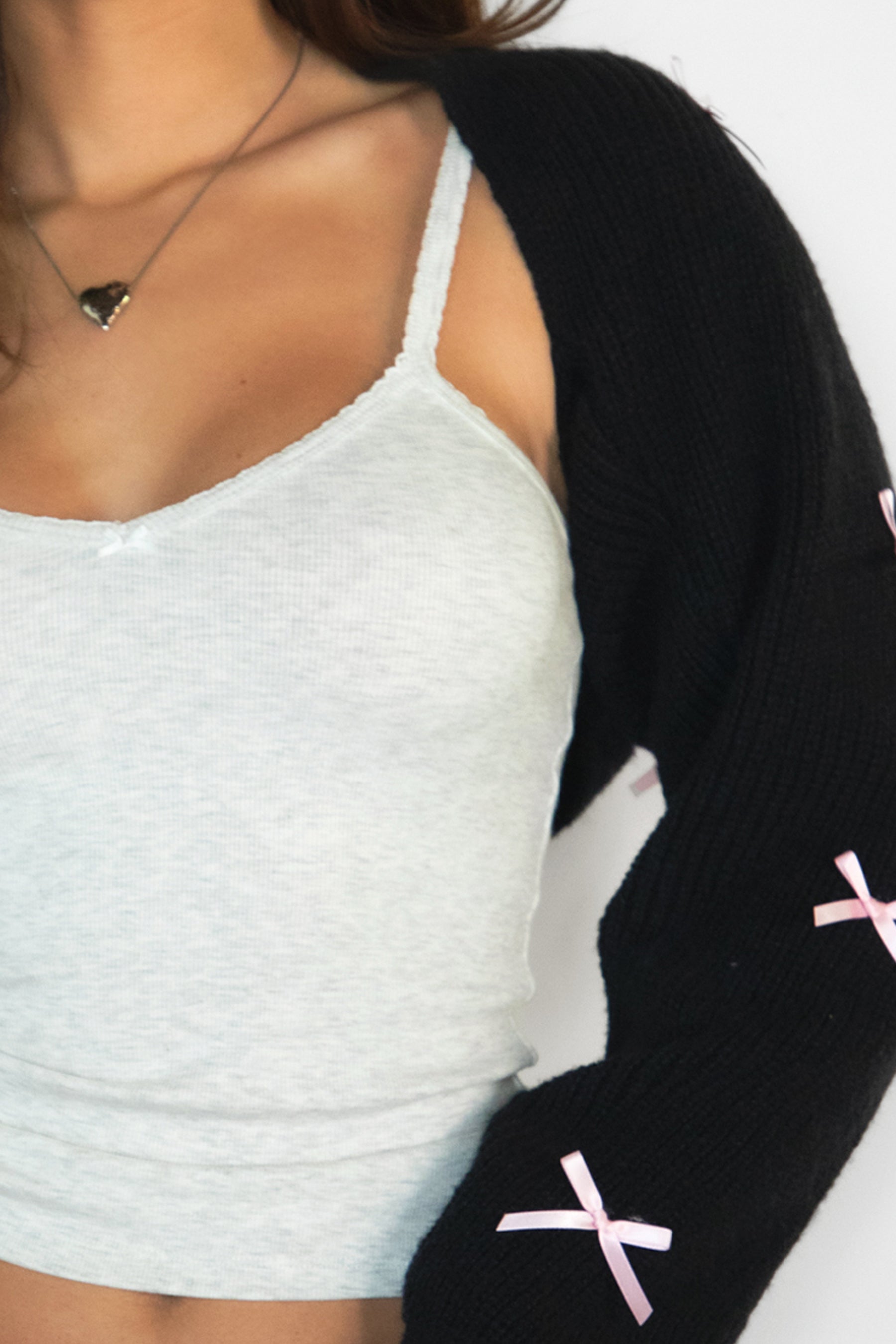 Woman wearing TIC TOC TH32025BA-ROMIE ROMIE V-neck spaghetti strap tank top featuring a delicate picot trim neckline, slim body hugging rib jersey fabric, and adjustable straps, styled with casual bottoms for an easy everyday lounge-and-layering look.