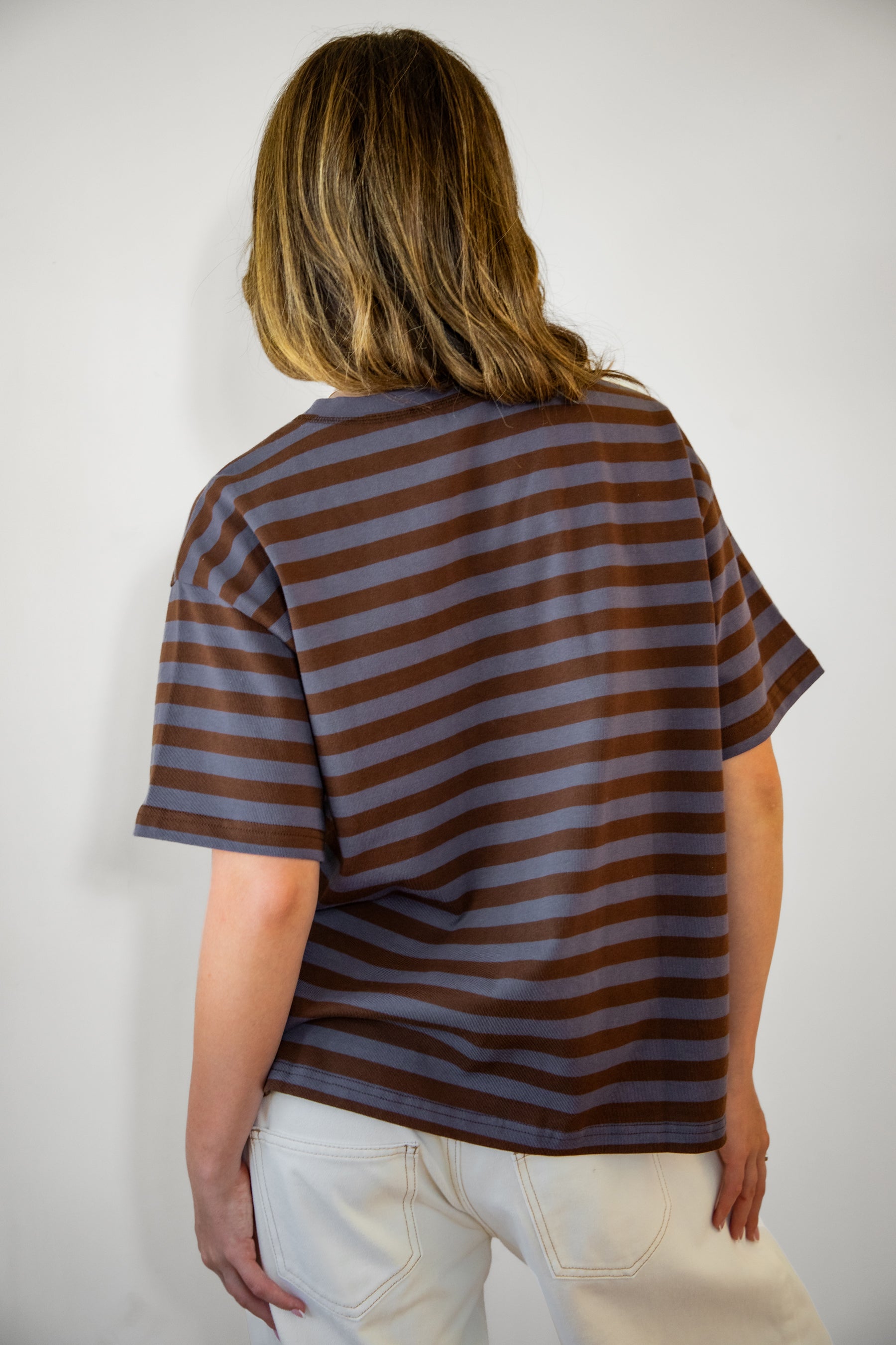 Woman wearing MARIN classic crewneck oversized striped short sleeve top featuring a timeless crew neckline, relaxed oversized fit, drop shoulder sleeves, soft horizontal stripe pattern, breathable 100% cotton fabric, and clean straight hem for everyday casual styling.