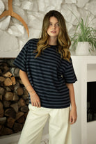 Woman wearing MARIN classic crewneck oversized striped short sleeve top featuring a timeless crew neckline, relaxed oversized fit, drop shoulder sleeves, soft horizontal stripe pattern, breathable 100% cotton fabric, and clean straight hem for everyday casual styling.