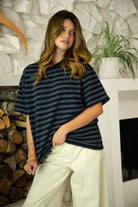 Woman wearing MARIN classic crewneck oversized striped short sleeve top featuring a timeless crew neckline, relaxed oversized fit, drop shoulder sleeves, soft horizontal stripe pattern, breathable 100% cotton fabric, and clean straight hem for everyday casual styling.