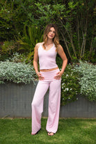 Woman wearing SAYLOR stripe double strap tank top featuring a V-neckline with contrast trim, double adjustable shoulder straps, mid length fitted silhouette, stripe stretch jersey fabric, and soft lightweight construction for casual lounge and athleisure styling.