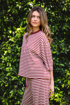 Woman wearing MARLOWE classic crewneck striped short sleeve top featuring a soft horizontal stripe pattern, relaxed semi oversized fit, drop shoulder short sleeves, lightweight stretch cotton blend, and clean straight hemline for casual lounge and coastal styling.