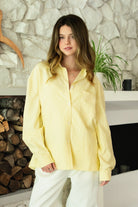 Woman wearing BLAIRE stripe oversized button down shirt featuring classic stripe oxford fabric, relaxed oversized silhouette, collared neckline, full front button closure, dropped shoulders, long sleeves with button cuffs, and functional chest pocket for effortless layering.