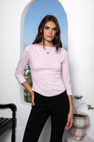 Woman wearing LUMA cotton rib three quarter sleeve boat neck top featuring soft cotton slub jersey, lightweight breathable feel, classic boat neckline, delicate picot trim, three quarter sleeves with matching cuff trim, picot trim hem, relaxed slim fit, and subtle curved hem.