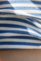 Woman wearing BRISA French terry stripe foldover waist wide leg pants featuring soft stretch French terry fabric, contrast foldover waistband, flattering low rise look, relaxed wide leg silhouette, classic stripe pattern, and pull on design for easy lounge and travel styling.