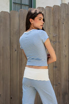Woman wearing BRISA French terry stripe crewneck short sleeve top featuring soft stretch French terry fabric, classic crewneck design, contrast neckband detail, slim fitted short sleeves, timeless yarn dye stripe pattern, and semi cropped length for easy everyday styling.