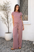 Woman wearing MARLOWE classic crewneck stripe short sleeve t-shirt featuring soft cotton blend fabric, lightweight comfortable feel, timeless striped pattern, classic crew neckline, short sleeves, relaxed slim fit, and effortless essential design for layering or everyday styling.