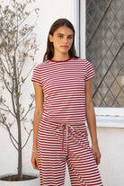 Woman wearing MARLOWE classic crewneck stripe short sleeve t-shirt featuring soft cotton blend fabric, lightweight comfortable feel, timeless striped pattern, classic crew neckline, short sleeves, relaxed slim fit, and effortless essential design for layering or everyday styling.
