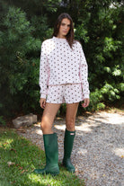 Woman wearing PIPPA polka dot plush fleece mock neck sweatshirt featuring soft cotton blend fleece fabric, allover polka dot print, classic crew neckline with ribbed trim, relaxed silhouette, long sleeves with dropped shoulders, ribbed cuffs and hem, and cozy construction designed to pair with the matching PIPPA shorts.