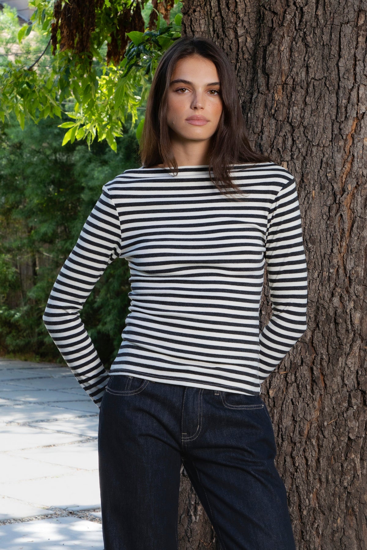 Woman wearing ROSLYN striped boat neck long sleeve top featuring soft brushed cotton stretch jersey fabric, classic horizontal stripe pattern, wide boat neckline that can be styled on or slightly off the shoulder, fitted silhouette, slim full length sleeves, and hip length hem for easy everyday styling.