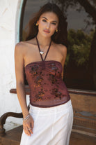 Woman wearing TIC TOC TC31322 KEZIA Mesh Sequin Embroidered Top with a matching maxi skirt and boots.