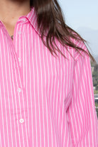 Woman wearing HAMPTON classic stripe collared cropped poplin shirt featuring classic stripe cotton fabric, crisp point collar, button front closure, ultra cropped relaxed silhouette, dropped shoulders, long sleeves with button cuffs, and clean back yoke detail for a polished modern tailored look.