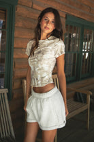 ASHLI Light Woodland Camo Jersey Baby Tee 
High Round Neckline Short Sleeve Top 
Short Cap Sleeves
Smooth Bodyhugging Stretch Fabric
Elevated Lounge Basic Top To Match Fleece Collection
Light Forest Woodland Camo in Dusted Grey
Back To School Western Rodeo Outfit Fashion Inspo