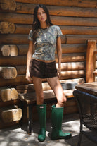 NOLA Woodland Camo Jersey Baby Tee 
Contrast High Round Neckline Short Sleeve Top 
Short Cap Sleeves
Smooth Bodyhugging Stretch Fabric
Elevated Lounge Basic Top To Match Fleece Collection
Forest Woodland Camo
Back To School Western Rodeo Outfit Fashion Inspo
