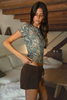 NOLA Woodland Camo Jersey Baby Tee 
Contrast High Round Neckline Short Sleeve Top 
Short Cap Sleeves
Smooth Bodyhugging Stretch Fabric
Elevated Lounge Basic Top To Match Fleece Collection
Forest Woodland Camo
Back To School Western Rodeo Outfit Fashion Inspo
