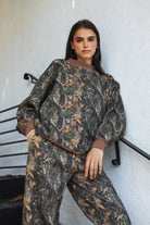Woman wearing BAYOU dark woodland camo mock neck sweatshirt featuring soft cloud fleece fabric, allover woodland camo print, wide mock neckline with contrast ribbed trim, dropped shoulder relaxed silhouette, oversized fit, long sleeves, and contrast ribbed cuffs and hem.