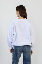 Woman wearing LANI mock neck cloud fleece sweatshirt featuring soft cotton blend cloud fleece fabric, ribbed mock neckline, relaxed oversized fit, dropped shoulder design, long sleeves with ribbed cuffs, triangle stitch detail at center front, and ribbed hem for a cozy comfortable finish.