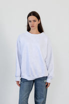 Woman wearing LANI mock neck cloud fleece sweatshirt featuring soft cotton blend cloud fleece fabric, ribbed mock neckline, relaxed oversized fit, dropped shoulder design, long sleeves with ribbed cuffs, triangle stitch detail at center front, and ribbed hem for a cozy comfortable finish.