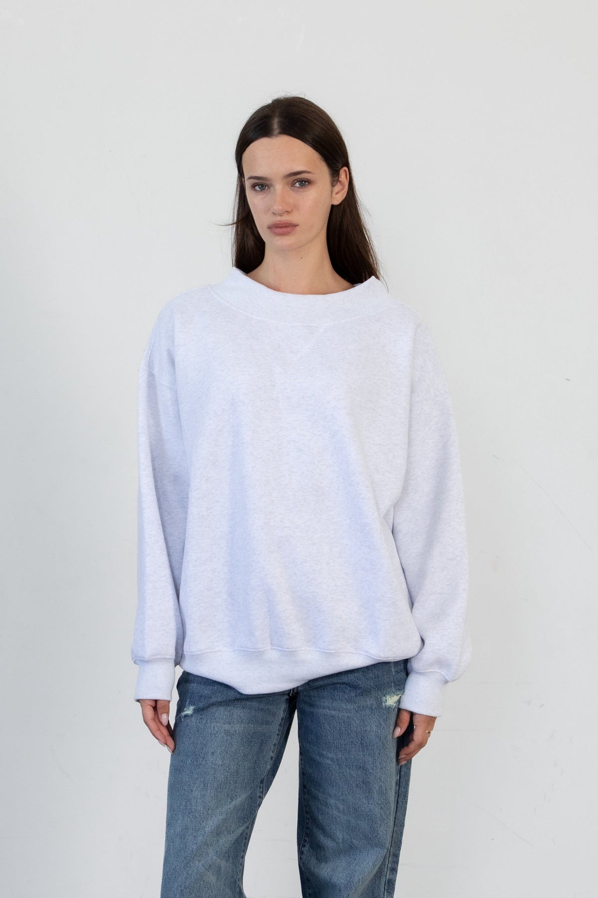 Woman wearing LANI mock neck cloud fleece sweatshirt featuring soft cotton blend cloud fleece fabric, ribbed mock neckline, relaxed oversized fit, dropped shoulder design, long sleeves with ribbed cuffs, triangle stitch detail at center front, and ribbed hem for a cozy comfortable finish.