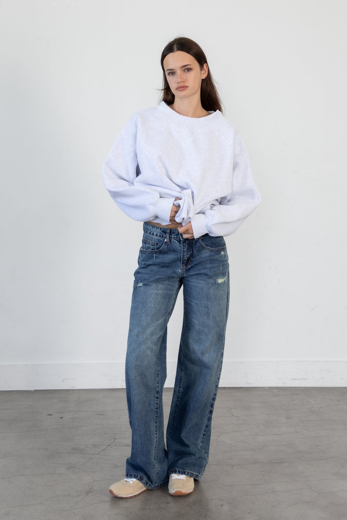 Woman wearing LANI mock neck cloud fleece sweatshirt featuring soft cotton blend cloud fleece fabric, ribbed mock neckline, relaxed oversized fit, dropped shoulder design, long sleeves with ribbed cuffs, triangle stitch detail at center front, and ribbed hem for a cozy comfortable finish.