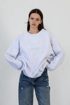 Woman wearing LANI mock neck cloud fleece sweatshirt featuring soft cotton blend cloud fleece fabric, ribbed mock neckline, relaxed oversized fit, dropped shoulder design, long sleeves with ribbed cuffs, triangle stitch detail at center front, and ribbed hem for a cozy comfortable finish.