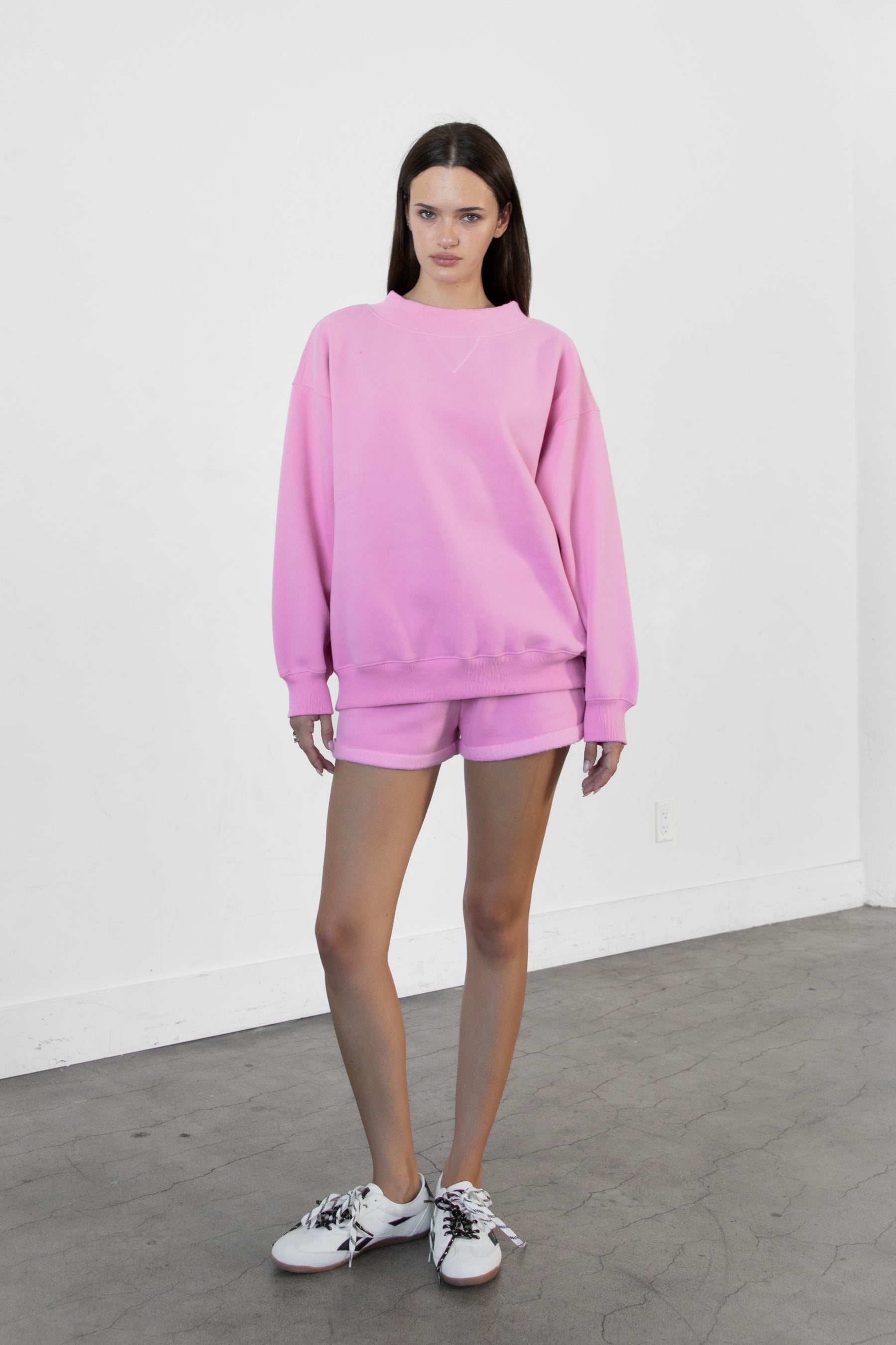 Woman wearing LANI mock neck cloud fleece sweatshirt featuring soft cotton blend cloud fleece fabric, ribbed mock neckline, relaxed oversized fit, dropped shoulder design, long sleeves with ribbed cuffs, triangle stitch detail at center front, and ribbed hem for a cozy comfortable finish.