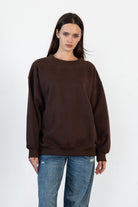 Woman wearing LANI mock neck cloud fleece sweatshirt featuring soft cotton blend cloud fleece fabric, ribbed mock neckline, relaxed oversized fit, dropped shoulder design, long sleeves with ribbed cuffs, triangle stitch detail at center front, and ribbed hem for a cozy comfortable finish.