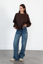 Woman wearing LANI mock neck cloud fleece sweatshirt featuring soft cotton blend cloud fleece fabric, ribbed mock neckline, relaxed oversized fit, dropped shoulder design, long sleeves with ribbed cuffs, triangle stitch detail at center front, and ribbed hem for a cozy comfortable finish.