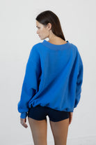 Woman wearing LANI mock neck cloud fleece sweatshirt featuring soft cotton blend cloud fleece fabric, ribbed mock neckline, relaxed oversized fit, dropped shoulder design, long sleeves with ribbed cuffs, triangle stitch detail at center front, and ribbed hem for a cozy comfortable finish.