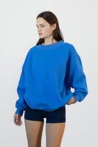 Woman wearing LANI mock neck cloud fleece sweatshirt featuring soft cotton blend cloud fleece fabric, ribbed mock neckline, relaxed oversized fit, dropped shoulder design, long sleeves with ribbed cuffs, triangle stitch detail at center front, and ribbed hem for a cozy comfortable finish.