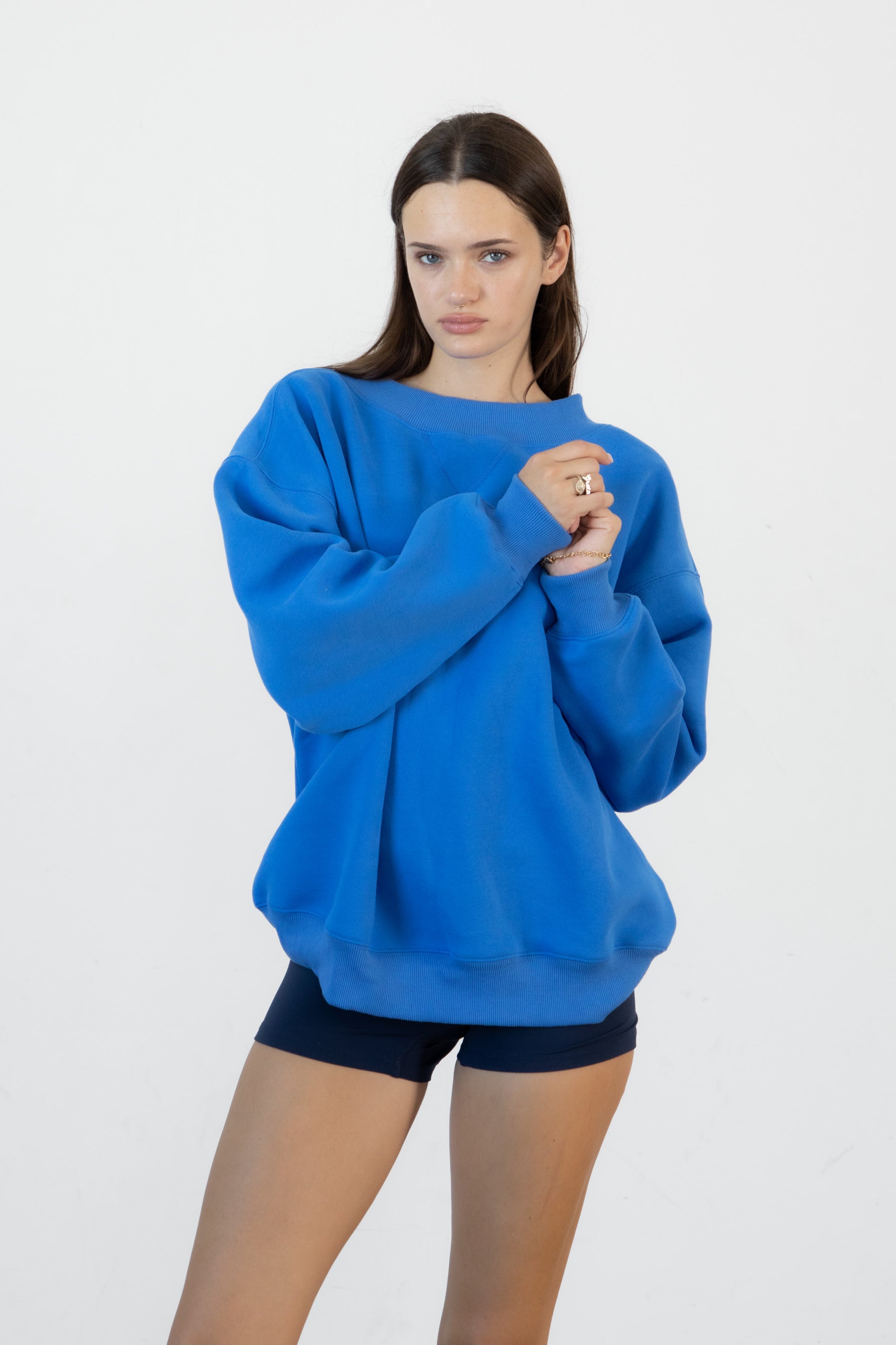 Woman wearing LANI mock neck cloud fleece sweatshirt featuring soft cotton blend cloud fleece fabric, ribbed mock neckline, relaxed oversized fit, dropped shoulder design, long sleeves with ribbed cuffs, triangle stitch detail at center front, and ribbed hem for a cozy comfortable finish.