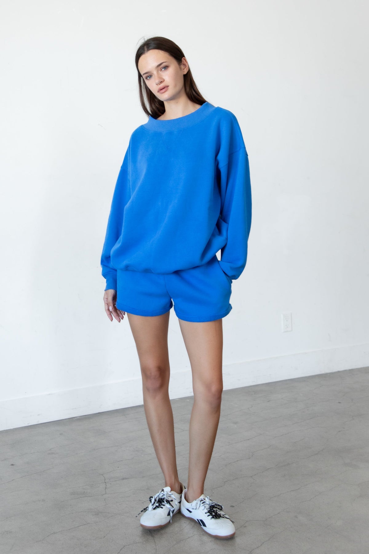Woman wearing LANI mock neck cloud fleece sweatshirt featuring soft cotton blend cloud fleece fabric, ribbed mock neckline, relaxed oversized fit, dropped shoulder design, long sleeves with ribbed cuffs, triangle stitch detail at center front, and ribbed hem for a cozy comfortable finish.