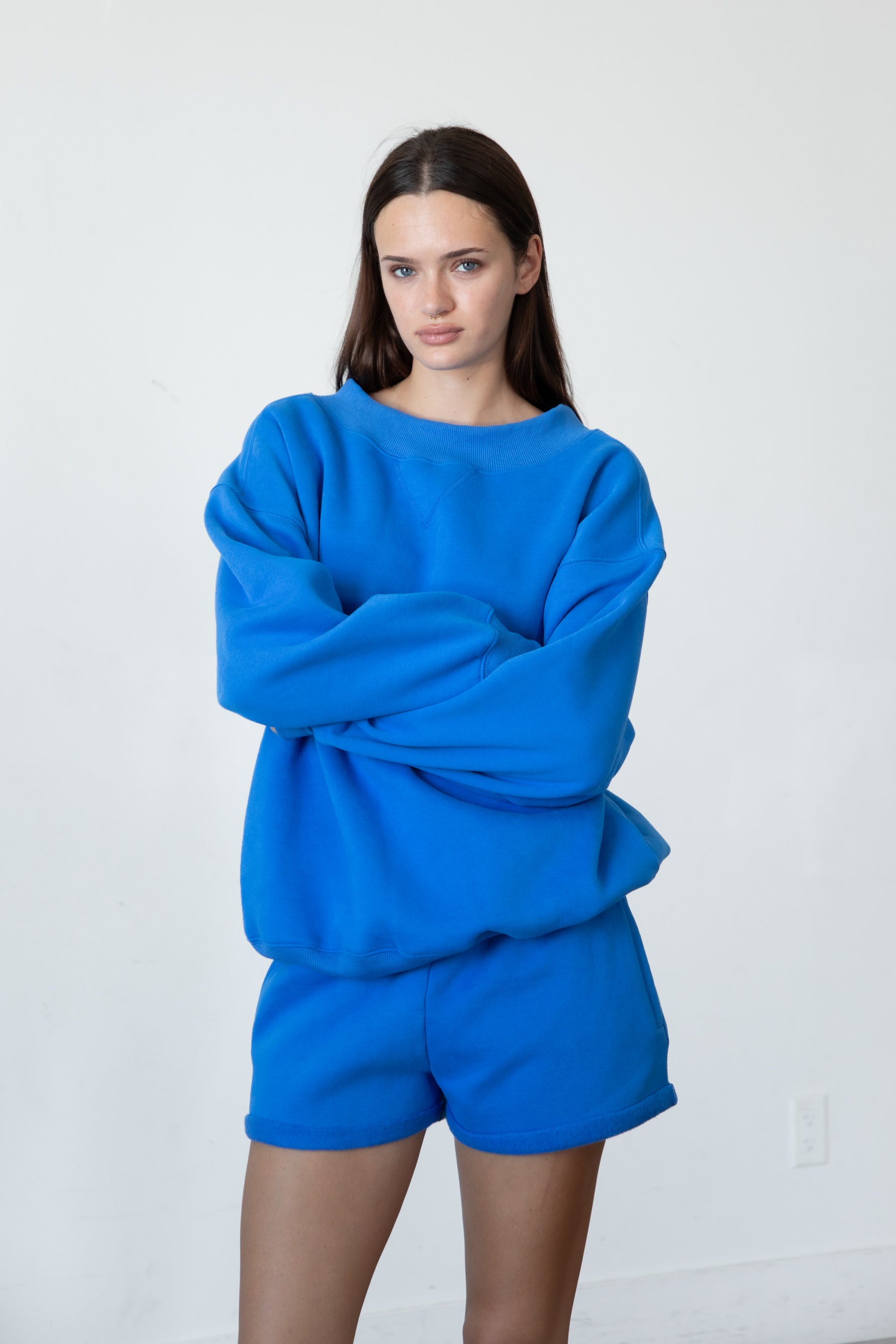 Woman wearing LANI mock neck cloud fleece sweatshirt featuring soft cotton blend cloud fleece fabric, ribbed mock neckline, relaxed oversized fit, dropped shoulder design, long sleeves with ribbed cuffs, triangle stitch detail at center front, and ribbed hem for a cozy comfortable finish.