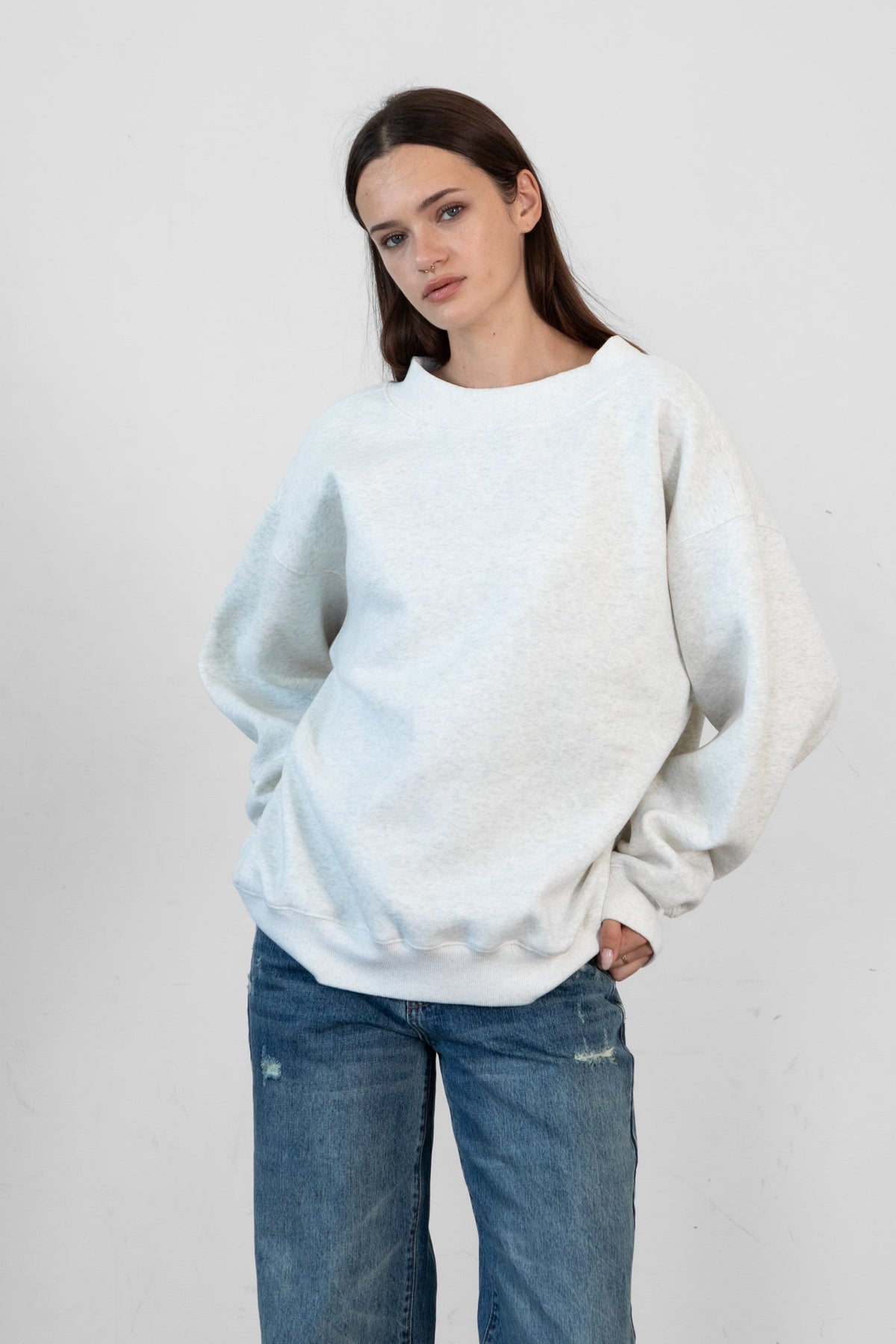 Woman wearing LANI mock neck cloud fleece sweatshirt featuring soft cotton blend cloud fleece fabric, ribbed mock neckline, relaxed oversized fit, dropped shoulder design, long sleeves with ribbed cuffs, triangle stitch detail at center front, and ribbed hem for a cozy comfortable finish.