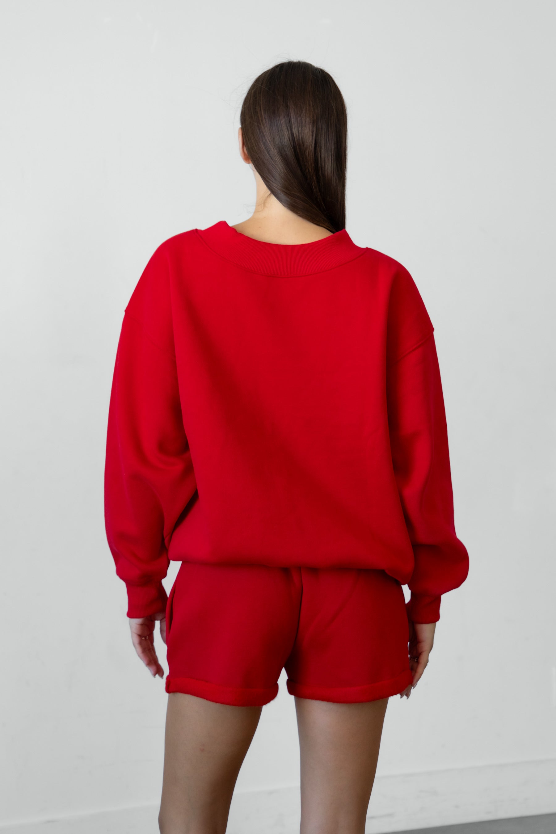 Woman wearing LANI mock neck cloud fleece sweatshirt featuring soft cotton blend cloud fleece fabric, ribbed mock neckline, relaxed oversized fit, dropped shoulder design, long sleeves with ribbed cuffs, triangle stitch detail at center front, and ribbed hem for a cozy comfortable finish.