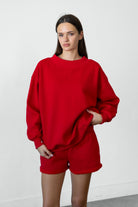 Woman wearing LANI mock neck cloud fleece sweatshirt featuring soft cotton blend cloud fleece fabric, ribbed mock neckline, relaxed oversized fit, dropped shoulder design, long sleeves with ribbed cuffs, triangle stitch detail at center front, and ribbed hem for a cozy comfortable finish.