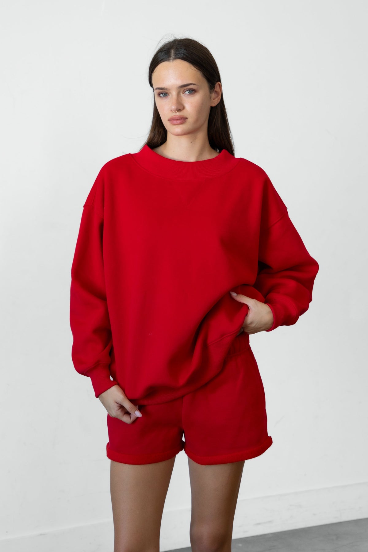 Woman wearing LANI mock neck cloud fleece sweatshirt featuring soft cotton blend cloud fleece fabric, ribbed mock neckline, relaxed oversized fit, dropped shoulder design, long sleeves with ribbed cuffs, triangle stitch detail at center front, and ribbed hem for a cozy comfortable finish.