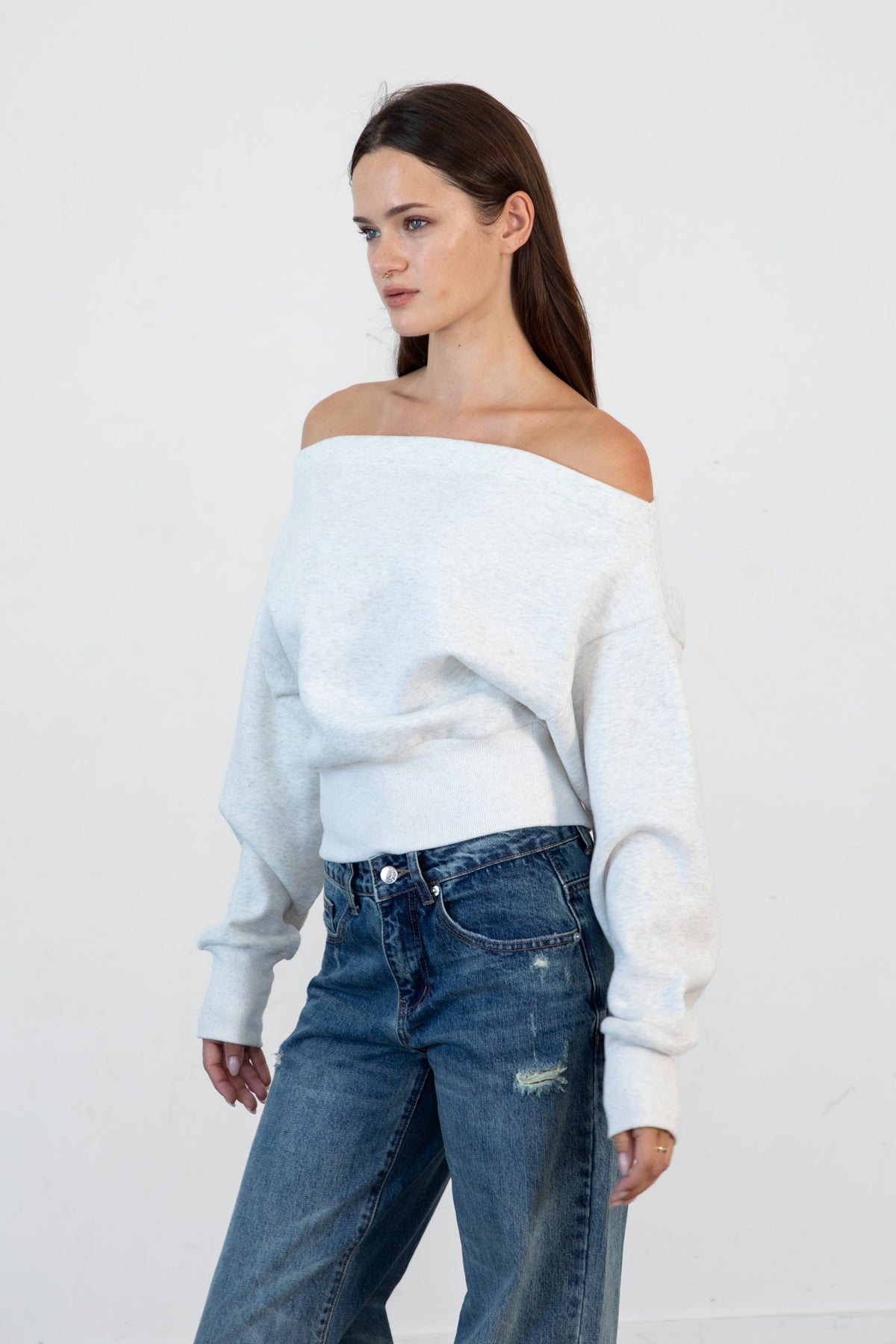 Woman wearing LANI mock neck cloud fleece sweatshirt featuring soft cotton blend cloud fleece fabric, ribbed mock neckline, relaxed oversized fit, dropped shoulder design, long sleeves with ribbed cuffs, triangle stitch detail at center front, and ribbed hem for a cozy comfortable finish.